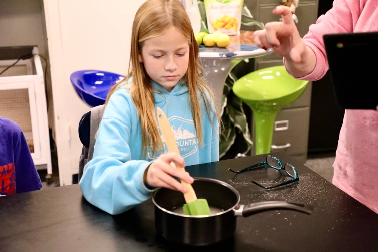 A student makes snacks at mini camp