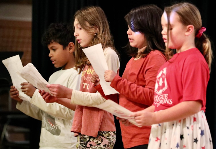 Students perform a reading 