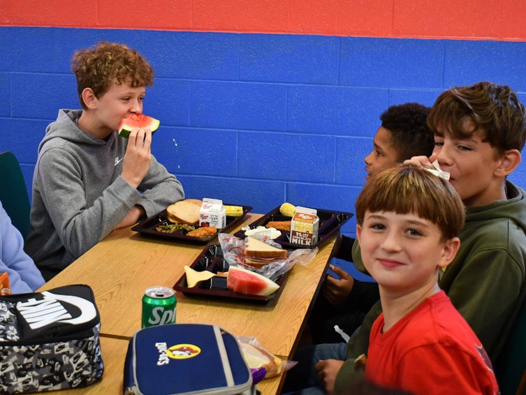 4 students eat lunch in cafeteria