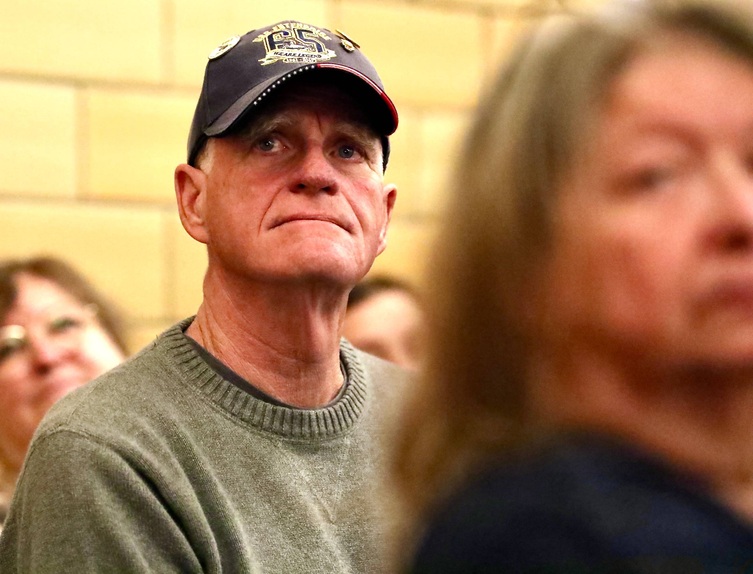 A veteran sits during the ceremony