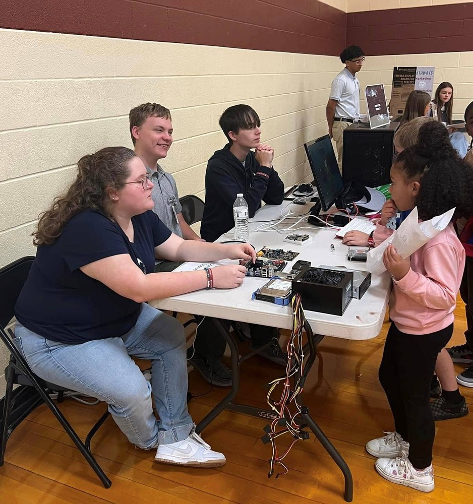 5 people at table with technical equipment on it