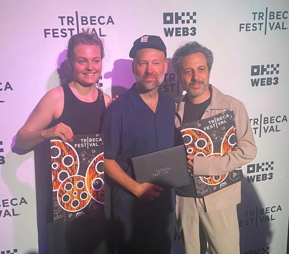 Simon Klose, flankerad av producenten Elin Kamlert och klipparen Nicolás Nørgaard Staffolani, tar emot priset för Bästa dokumentär på Tribeca Festival. Foto: Sara Rüster. 