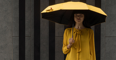 a woman with a yellow umbrella
