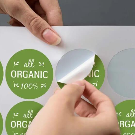 Green stickers printed on a sheet of sticker paper 