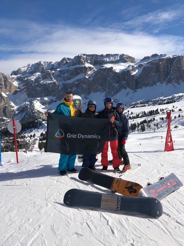 Grid Dynamics team riding on snowboards