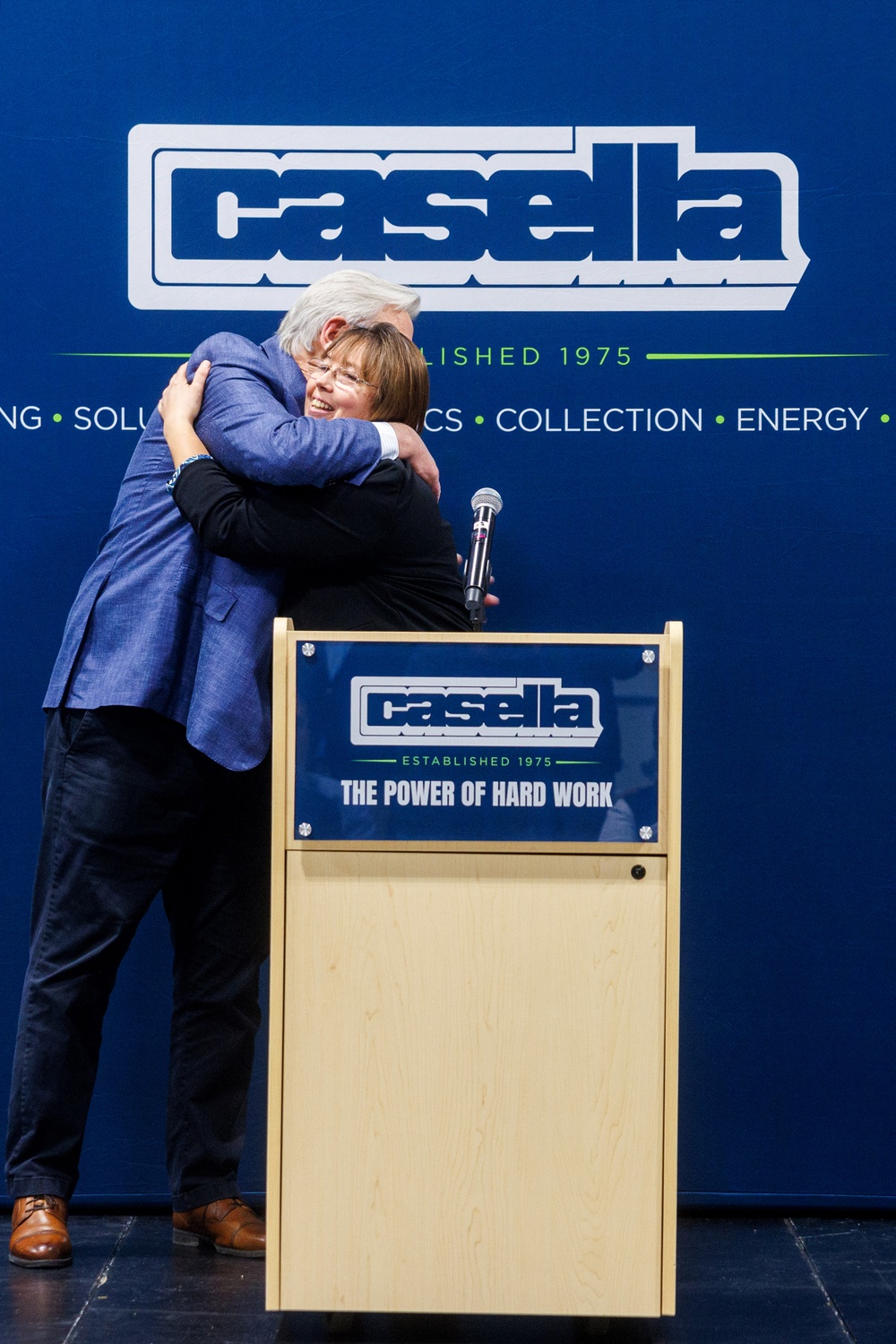 John Casella, Chairman & CEO of Casella Waste Systems, Inc. hugs Courtney Hier, daughter of Ken Hier Sr. at the dedication of the Kenneth A. Hier Sr. CDL Training Center.