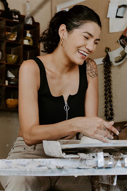 woman with dark ponytail with clay