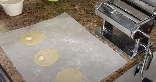 Discs of dough with filling on the kitchen table
