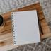Wooden table with coffee cup and notepad