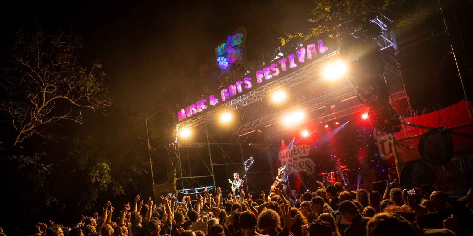 Under The Trees Music and Arts Festival's banner