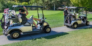 Team of four players sharing two carts