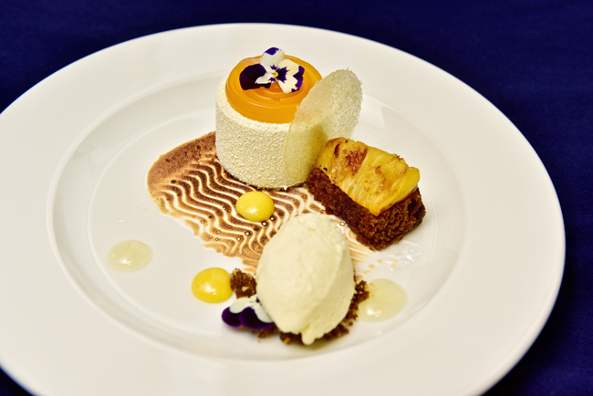 White chocolate set cream, passion fruit jelly, toasted coconut meringue, caramelised salt-baked pineapple, Jamaican ginger cake, lime gel, passion fruit curd and pineapple sorbet