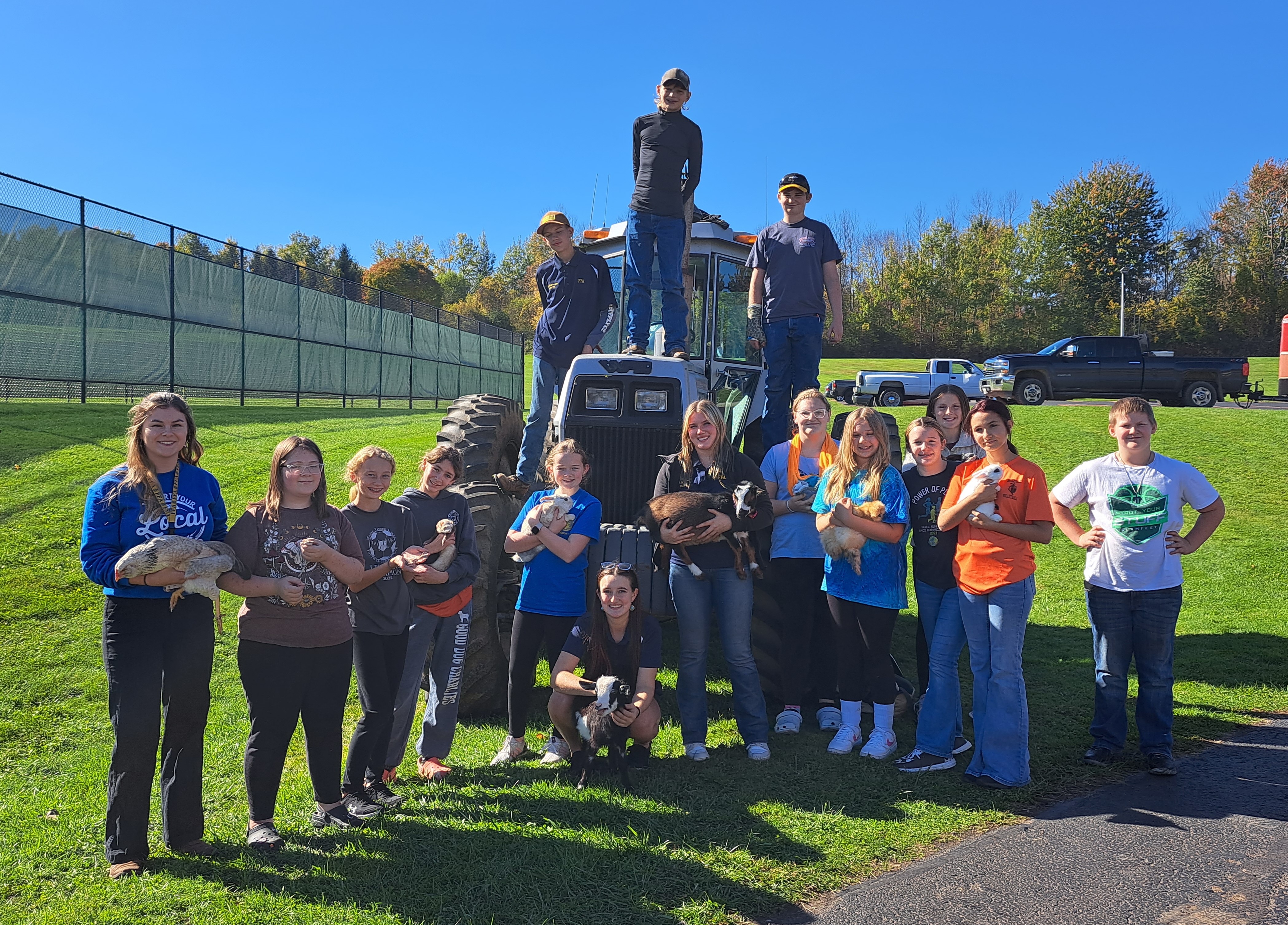 FFA members pose near a tractor