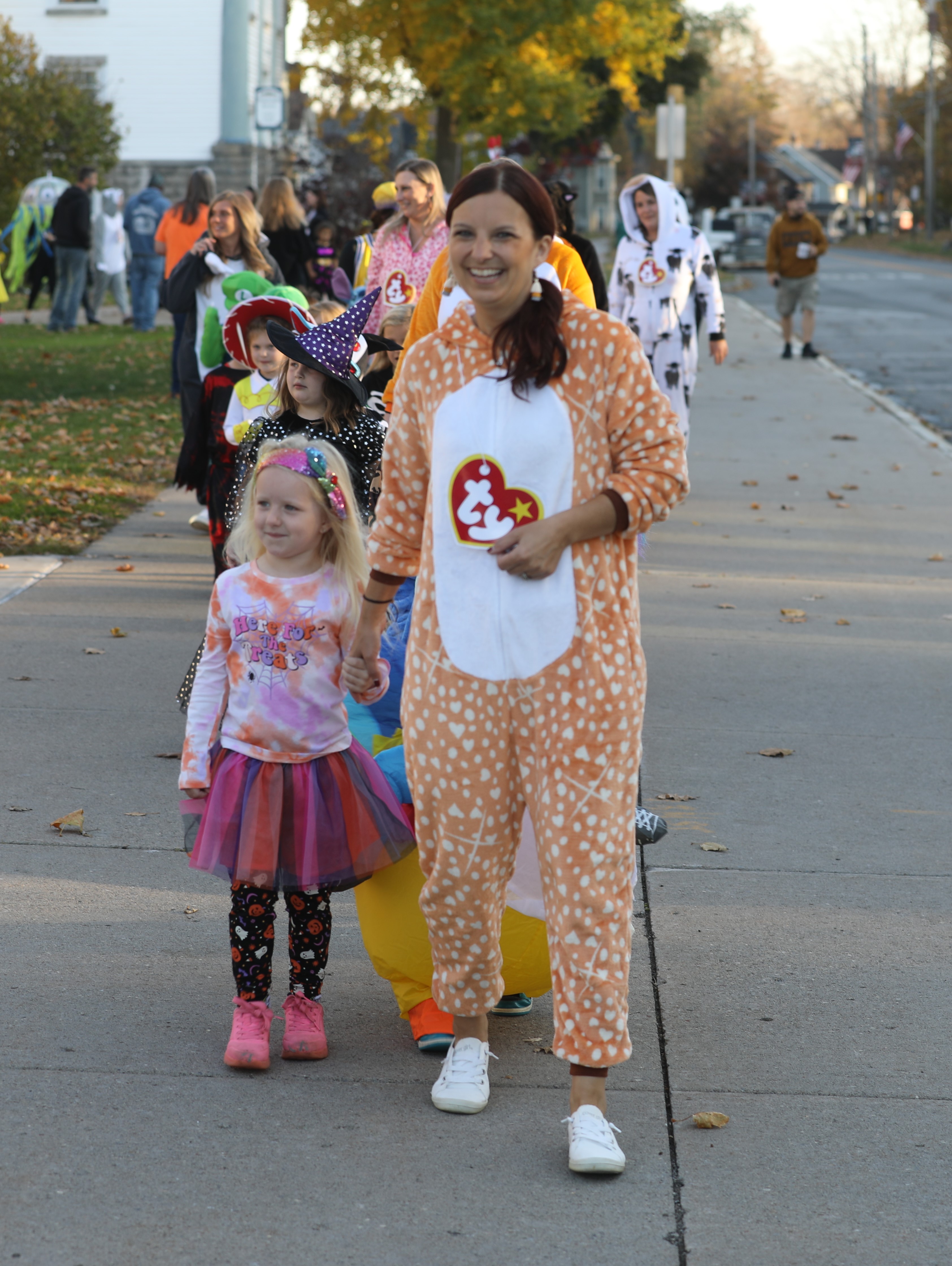 Teacher and student walking in K-2 costume parade