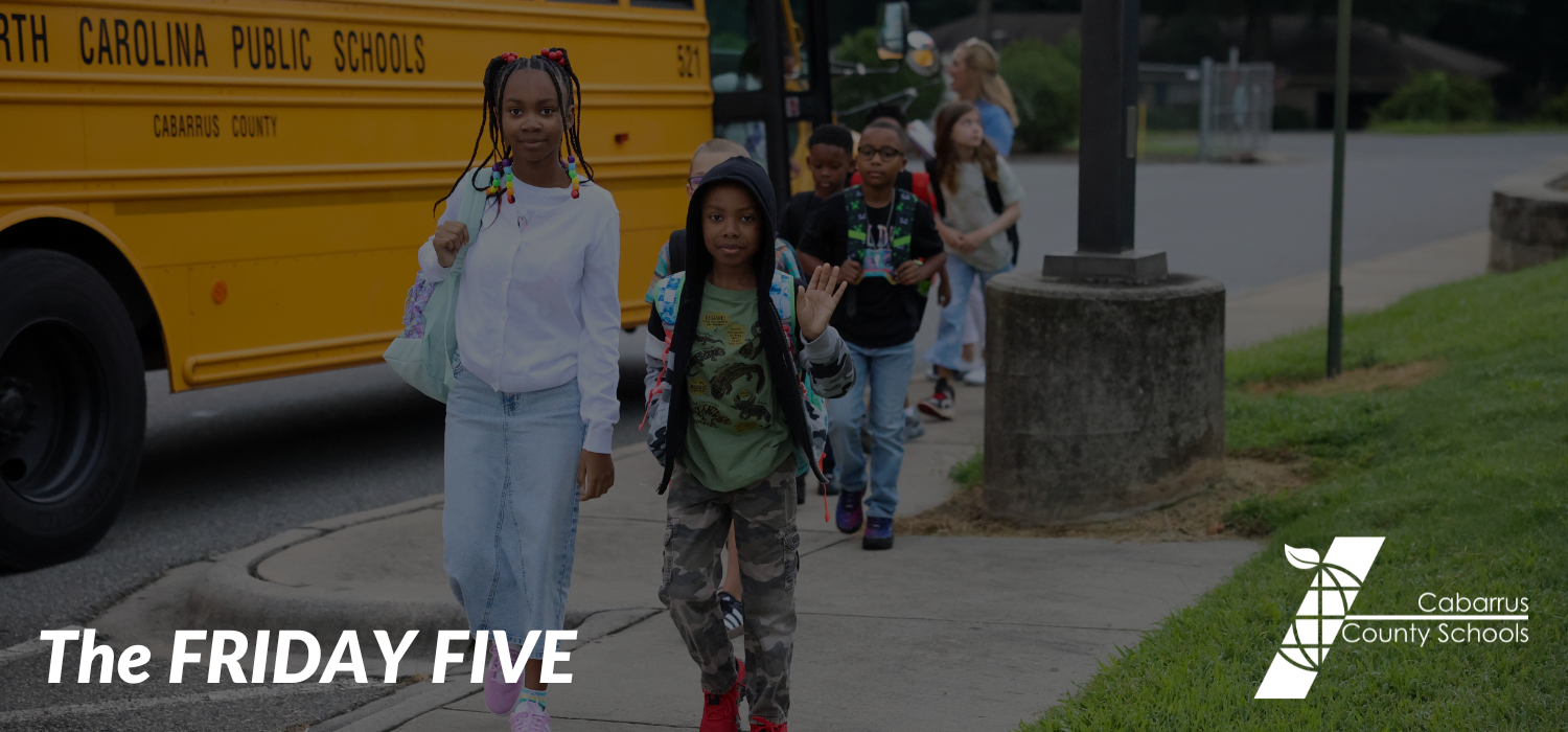 A student holding up five fingers.