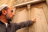 Meir Tweg Synagogue, A Shiite Muslim Iraqi Who Cares for the Shrine of Ezra Points to a Hebrew Inscription on a Holy Ark (Baghdad, Iraq)