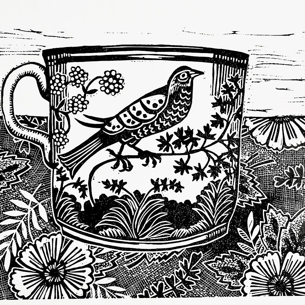 Black and white print of a cup featuring a bird design. The cup is surrounded by a floral pattern.