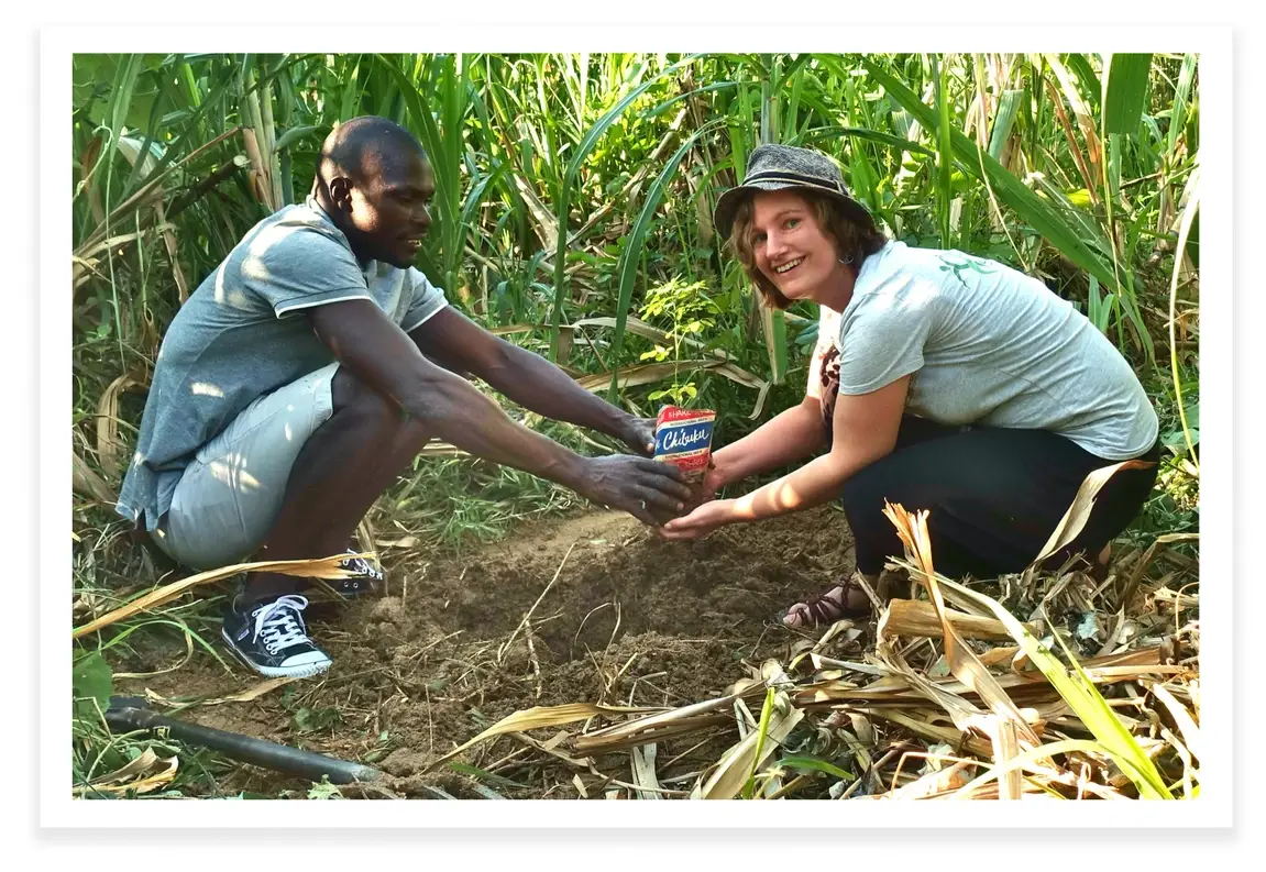 Susanne Friedrich, founder of Green Spark, and partner Alex Ndipo in a field.