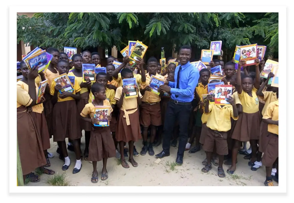 Donating books to schoolchildren in Ghana.