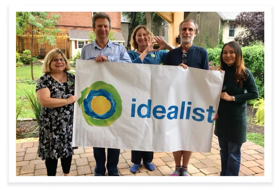 The Idealists of Philadelphia holding up a banner that says Idealist.