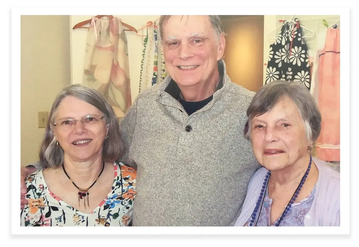 Three attendees of an Idealist Day event smile for a picture.