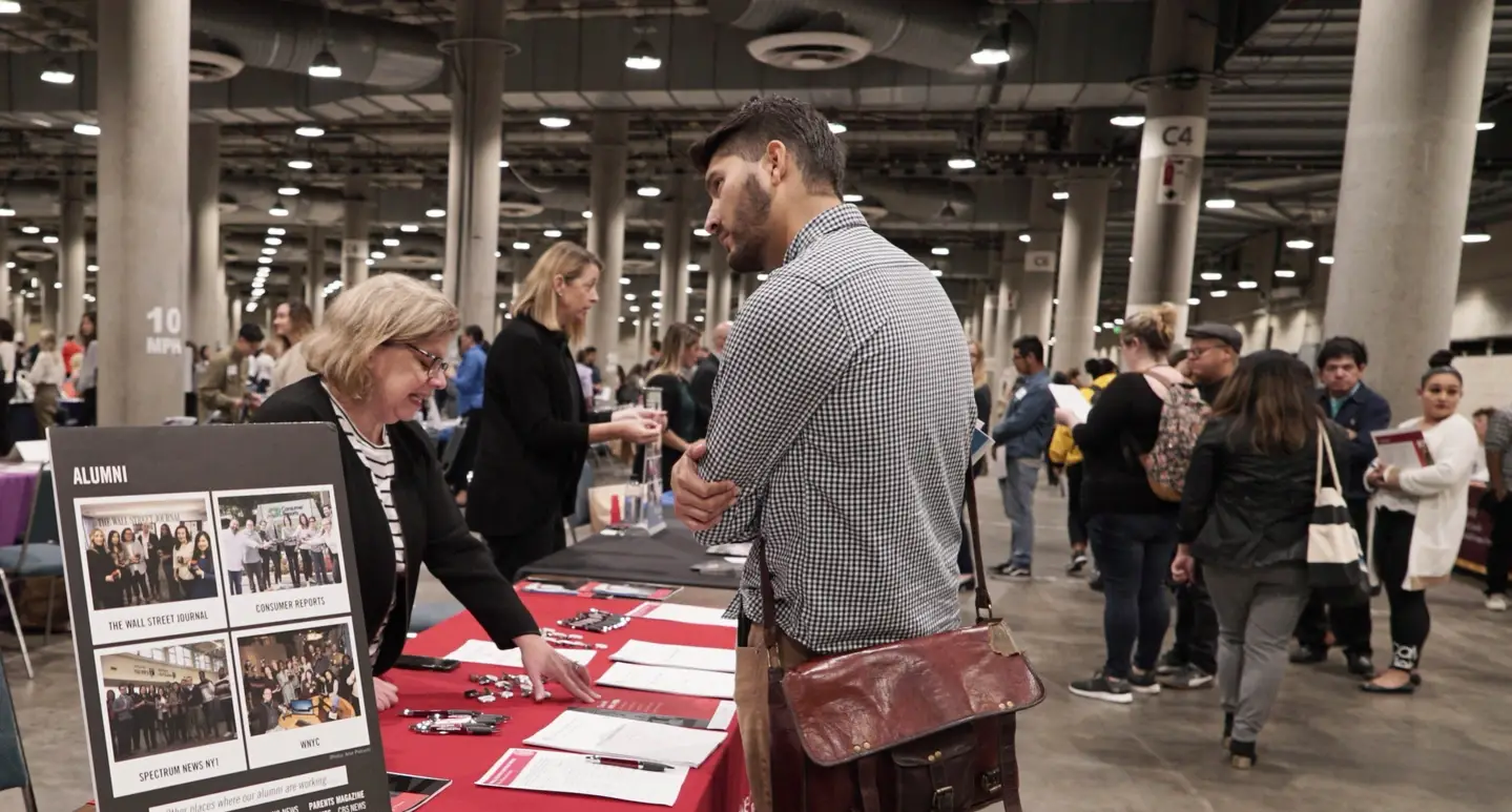 A photograph of two recruiters at the Idealist Grad School Fair in New York in 2019.