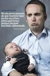 A man holding a baby. They are both frowning.