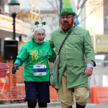 Saint Patrick's Day Runfest, senior runner with leprechaun mascot