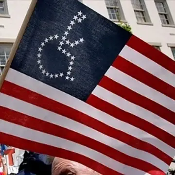 American flag with the white stars in the shape of the wheelchair icon