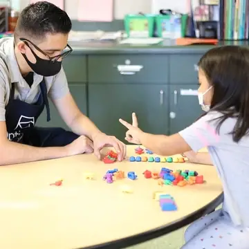 Preschool teacher with child