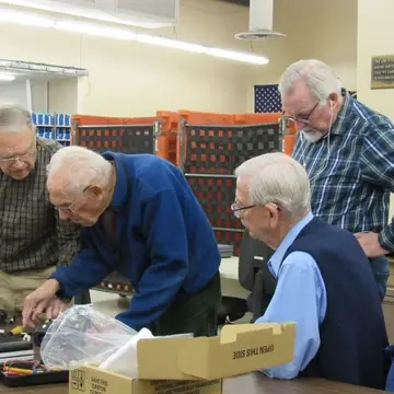 Four experienced volunteers work to solve why a machine malfunctioned.