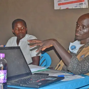 CECI Uganda Founder and Executive Director Patrick Chandiga Justine Abure meeting with local communities in Village one Bidibidi refugee settlement for establishment of the Salaam Radio