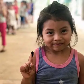One of the kids from casa Guatemala showing her finger after internal elections