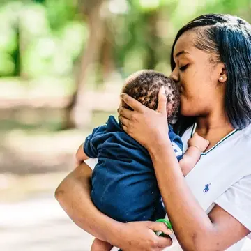 Woman kissing baby's head