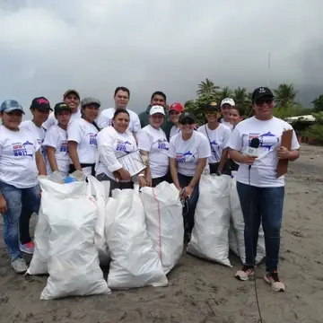 Volunteers show off the garbage bags they filled during an International Coastal Cleanup in Nicaragua.