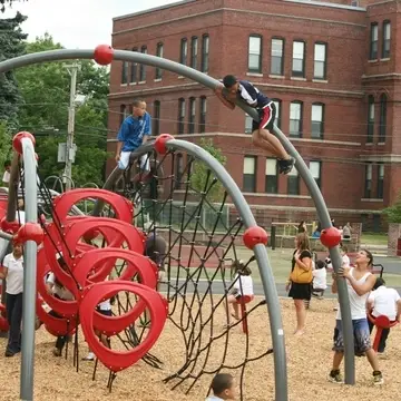 Kids play on a large playground equipment