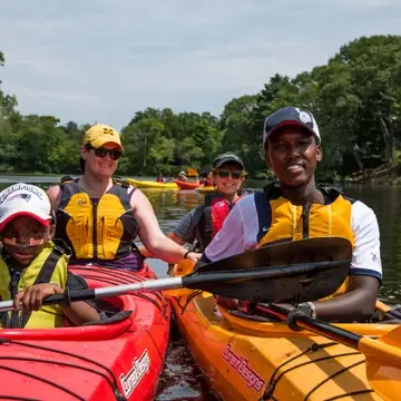 Four Waypoint participants and volunteers kayaking on the Charles River