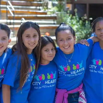 A group of five diverse City Hearts students smiling
