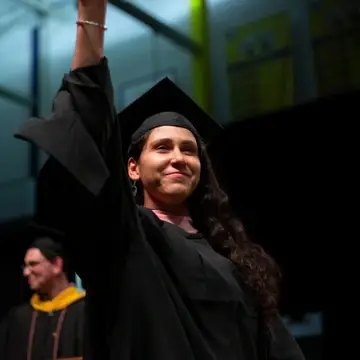 MPH Student walking across graduation stage