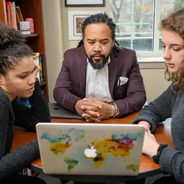 Professor Roderick Carey works with two students