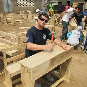 GROUP OF STUDENTS MAKING TABLES AND CHAIRS FOR DONATION TO THE STREET KIDS AND ORPHANS