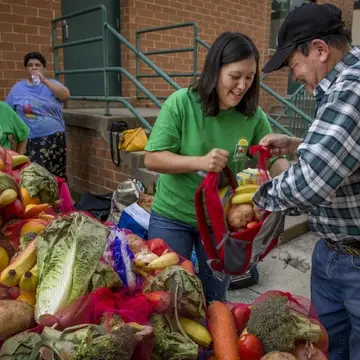 Volunteers helping bag food for families