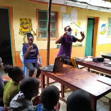A visitor teaching kids at smile community cenre