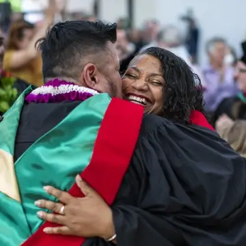 Divinity students hugging at graduation