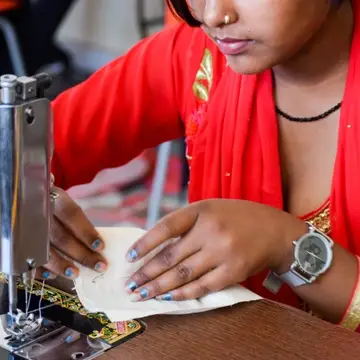 Sewing student working with sewing machine at Sewing New Futures' center in New Delhi