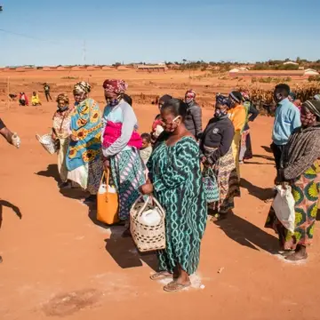 Refugee women waiting to receive our emergency food provisions