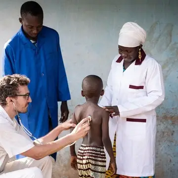 A team of health experts examining a child at a health centre