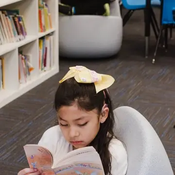 Two students read in the school library.