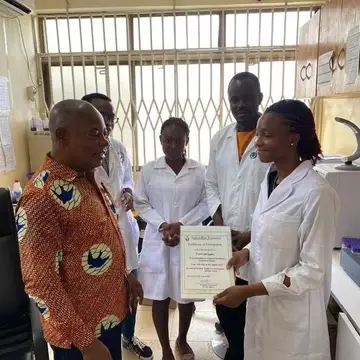 Healthcare Volunteer receiving certificate of participation from Gate of Hope Volunteer Service, Ghana.