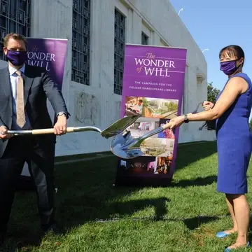 Director of Folger and Board Member digging with shovels to break ground on the new renovation